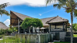 A resort with a thatched-roof pavilion, a pool area, and a well-maintained lawn. - Luxury Beach Front Villa with large garden, private pool, staff and free Wi-fi (Singaraja)