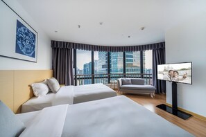 A hotel room with two beds, a TV, a city view, and a modern design. - Joysuites Nantong (Nantong)
