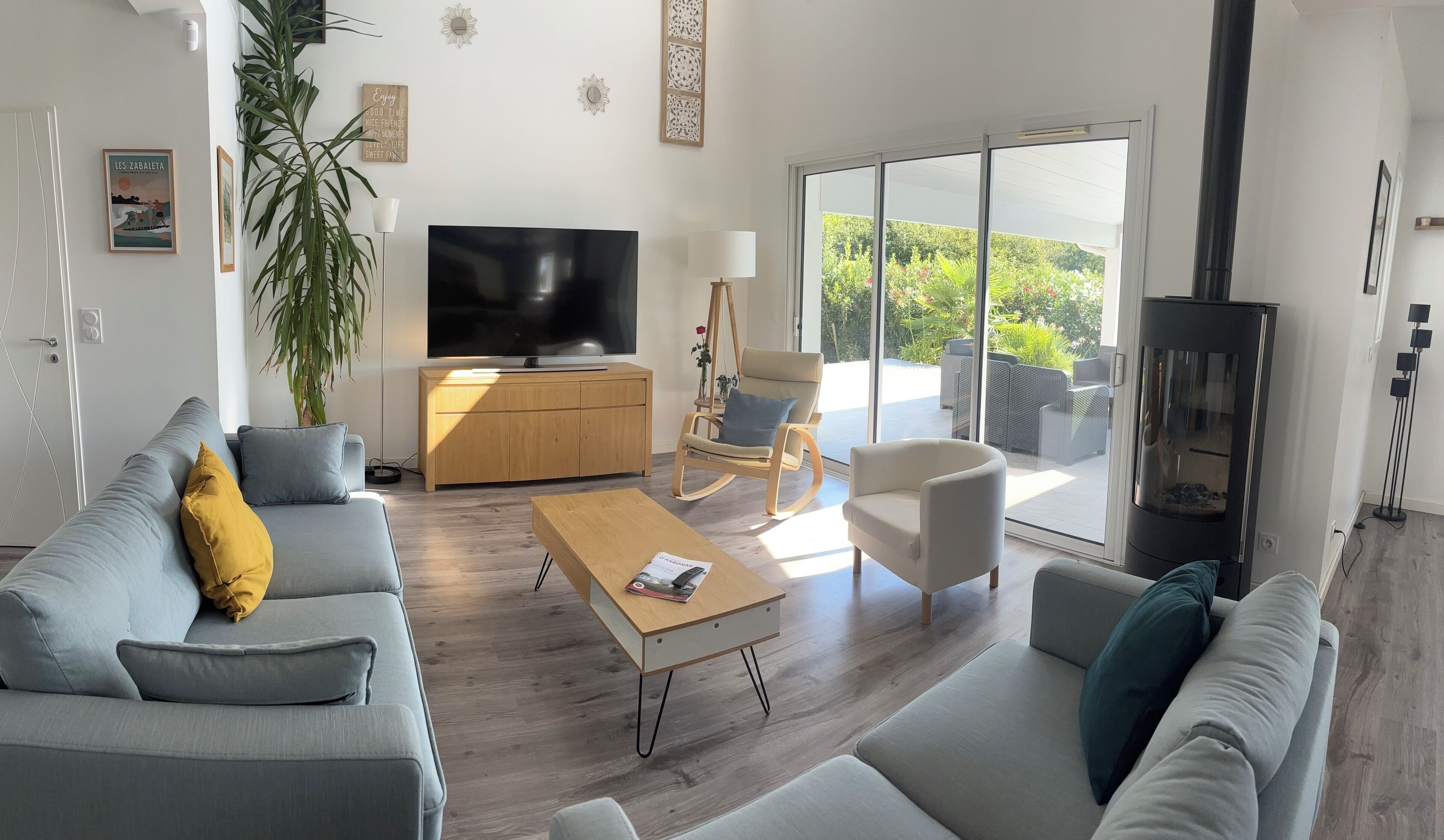 A modern living room with a sofa, coffee table, and a TV.