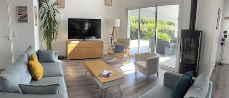 A modern living room with a sofa, coffee table, and a TV.