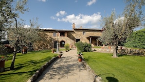 A stone building with a paved pathway leading to the entrance. - Romantic With Chianti Panorama (Bucine)
