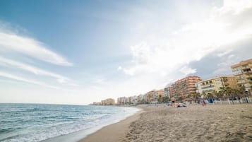 On the beach, white sand, sun-loungers, beach umbrellas