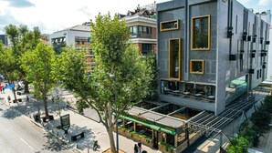 A modern hotel with a prominent 'BROW' sign, outdoor seating, and a pedestrian-friendly street view. - Broyt Hotel (Istanbul)
