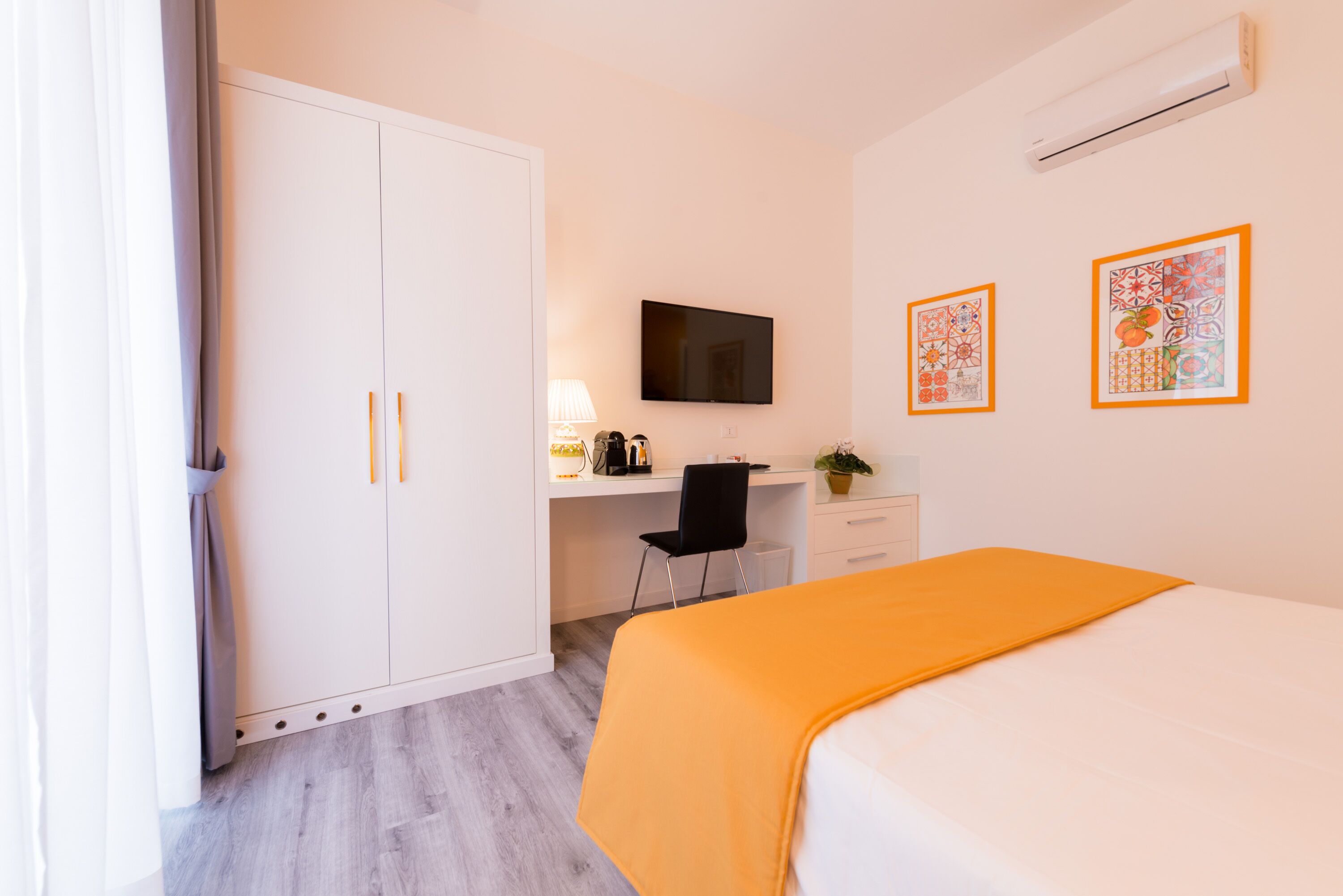 A bedroom with a bed, a desk, a chair, and a wardrobe.
