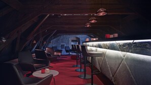An interior with a bar area, seating, and a view through a window. - Boutique Hotel Schlossberg (Thun)