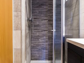 Appartement (1 Bedroom) | Badkamer | Een douche, handdoeken, toiletpapier