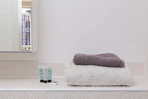Shower, hair dryer, towels, shampoo