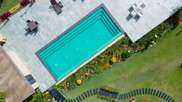 Outdoor pool, a heated pool, pool umbrellas, pool loungers