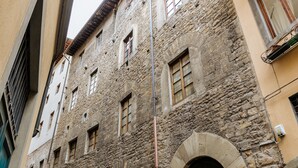 A stone building with multiple windows and a visible utility pole.