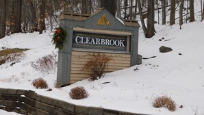 A wooden sign with "CLEARBROOK" written on it, surrounded by snow and trees. - Sun Soaked Views, Pool, Spa; and Spectacular Mountain Views (Lincoln)