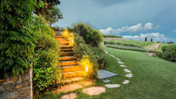A stone staircase leading up to a building, surrounded by lush greenery and a well-maintained lawn. - Luxury Chianti Between Grapes (Greve in Chianti)