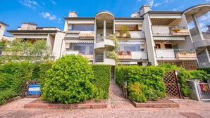 A multi-story residential building with balconies, a central courtyard, and a gated entrance. - Residenza Verde (Desenzano del Garda)