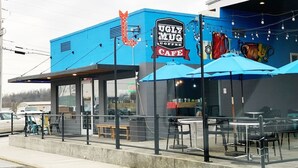A blue building with a sign that reads "UGLY MUG COFFEE CAFE".