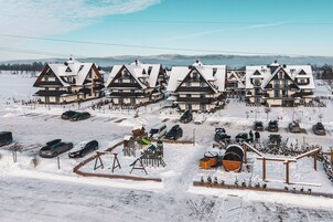 A row of chalet-style buildings with a ski lift in the background.