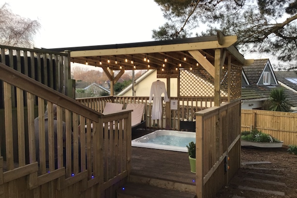 Tiered luxury quality decking leads down to secure garden