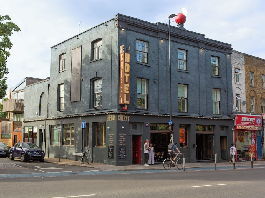A two-story building with a sign reading "The Cherry Hotel."