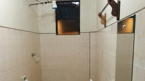 A small bathroom with a toilet, a sink, and a green basin.