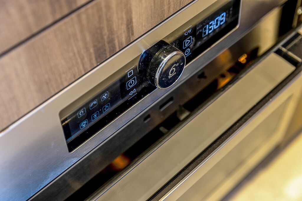 A control panel with a digital display and a rotary knob, likely for adjusting settings.