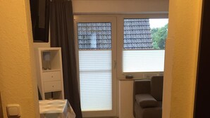 A compact living space with a kitchenette, a dining area, and a seating area.