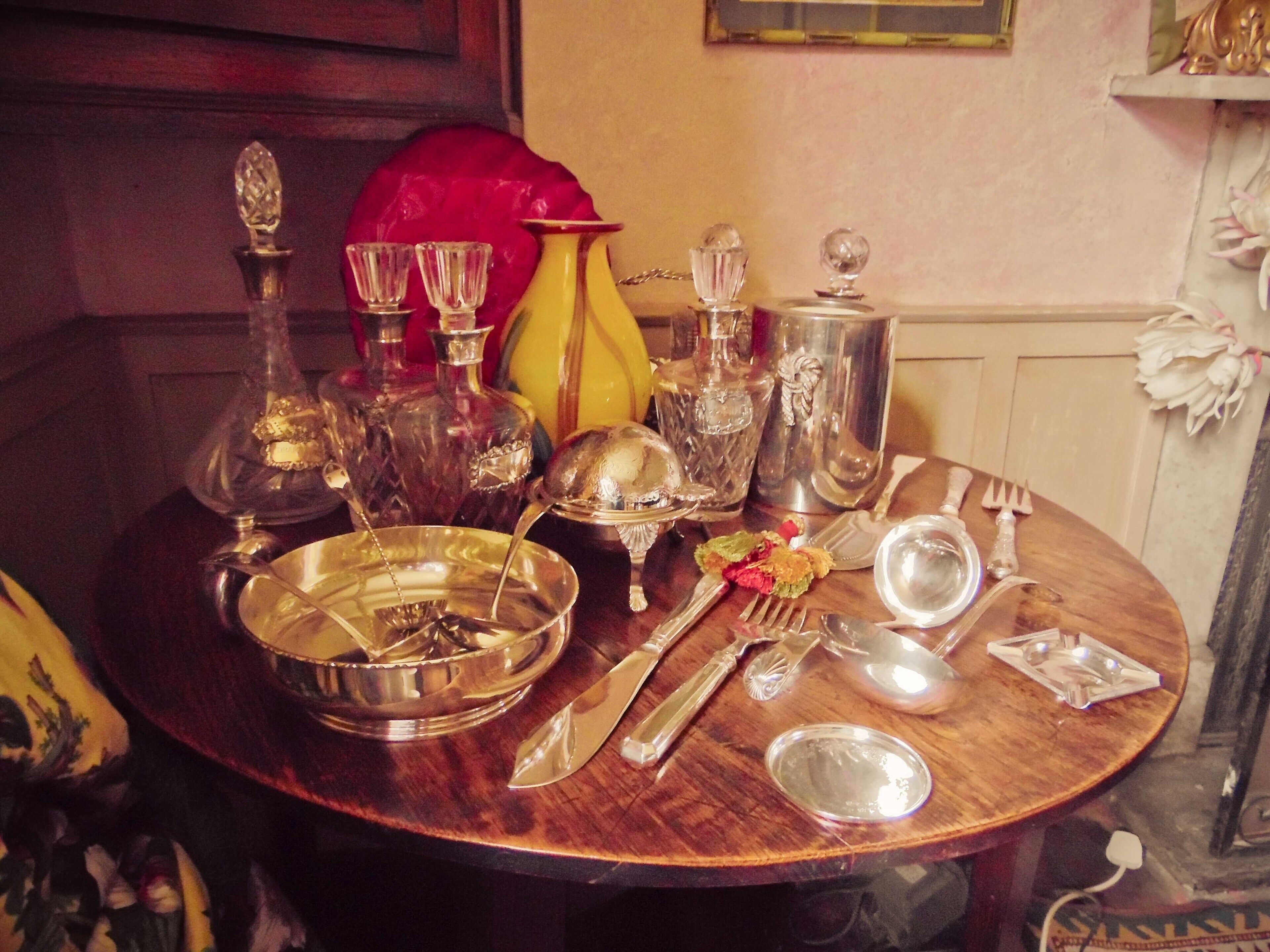 A dining table set with silverware, plates, and glassware.