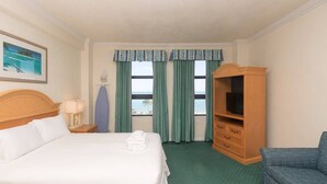 A hotel room with a bed, a TV cabinet, a chair, and a view of the ocean. - 631 Ocean View Hollywood (Hollywood)