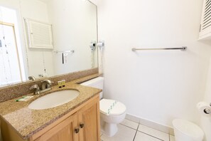 A bathroom with two sinks, a toilet, and a mirror. - 764 Ocean View Hollywood Beach (Hollywood)