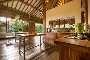 A spacious kitchen with wooden countertops, a dining area with a large table, and a view of lush greenery outside. - Beautiful Villa with Private Pool, Bali Villa 2049 (Bali)