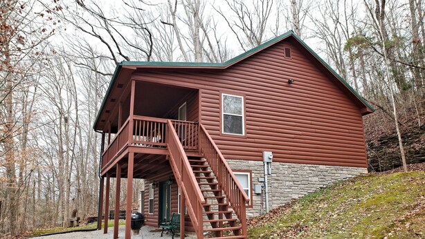 A cabin with a wooden deck and a staircase leading to a porch. - Morehead Cabin on the lake (Morehead)
