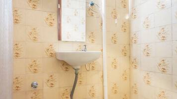 A bathroom with a toilet, bidet, and sink.