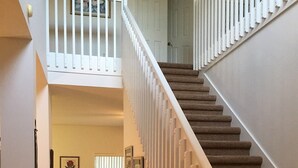 A staircase with white railings leading to a second floor. - 4636 5-bed Disney Area Pool Home, Cumbrian Lakes (Kissimmee)
