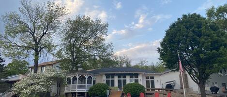 A house with a porch, a flagpole, and a bridge.