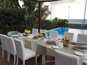 Outdoor dining - Luxury seafront villa with pool (Messina)
