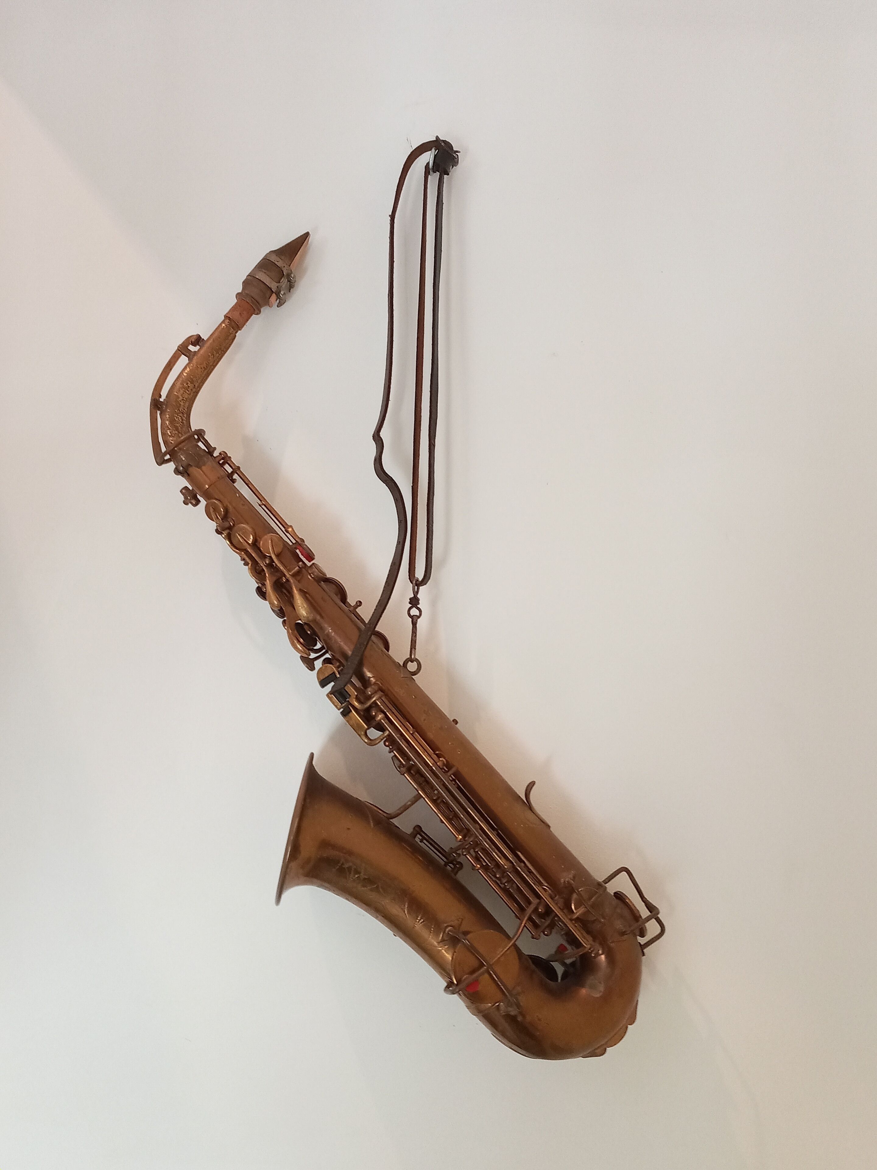 A saxophone mounted on a wall.