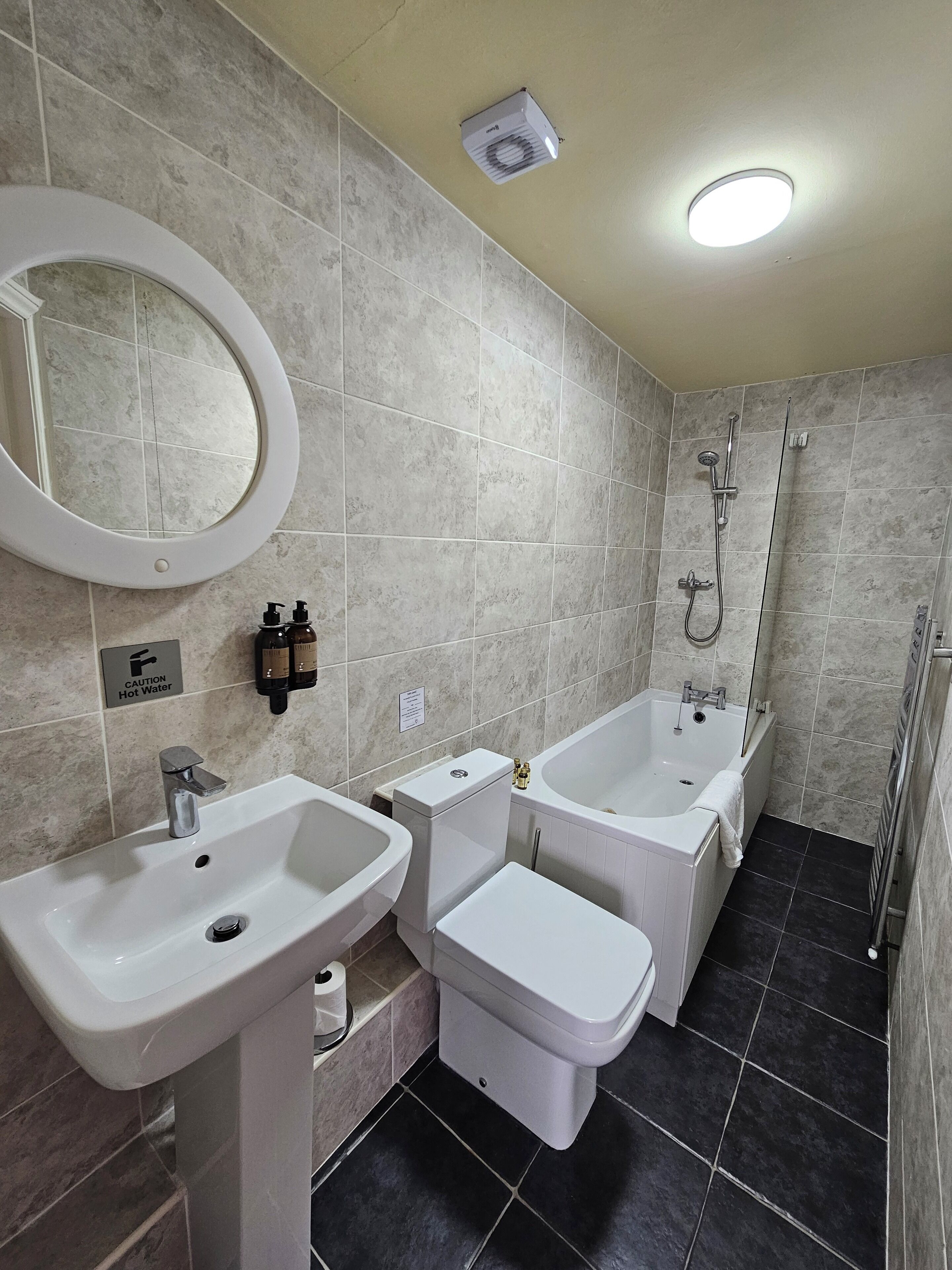 A bathroom with two sinks, a toilet, a bathtub, and a shower.