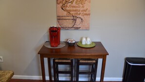 A small dining table with a coffee maker, cups, and a decorative coffee-themed wall hanging. - 2BA 6-Beds 10-min to downtown Nashville! (Nashville)