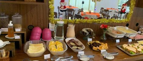 A buffet area with various food items and utensils.