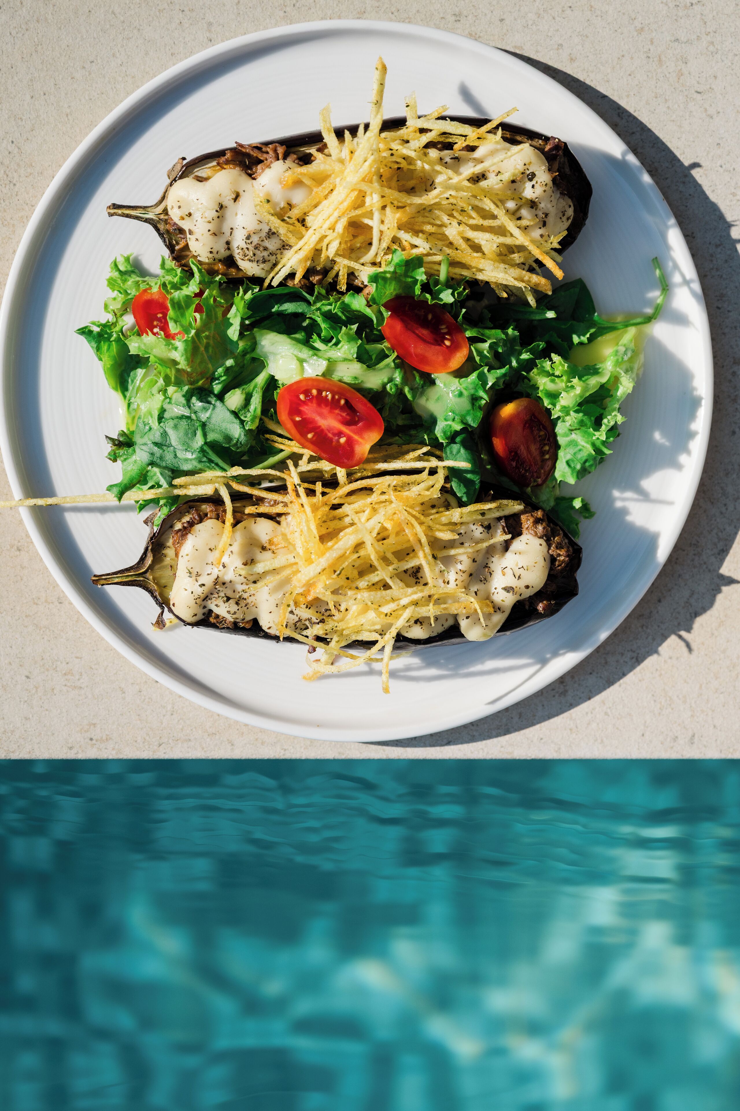 A plate of stuffed mushrooms with cheese and a side salad.