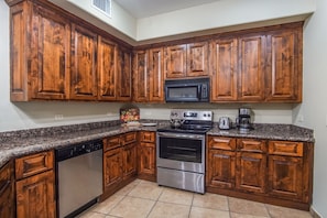 Enjoy cooking in this well-equipped kitchen with a dishwasher, oven, and microwave.