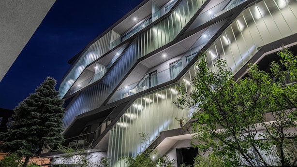 A modern building with multiple floors, large windows, and a staircase. - Blend City Center (Bucharest)