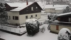 Zona residencial con casas cubiertas de nieve, que muestra una combinación de arquitectura moderna y tradicional.