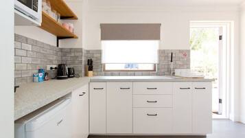 Fridge, microwave, stovetop, coffee/tea maker