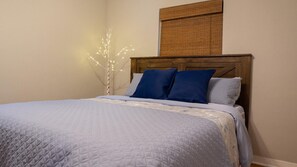 Restful retreat with a cozy bed and a unique light fixture.