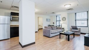 A modern apartment with a kitchen, living room, and dining area.