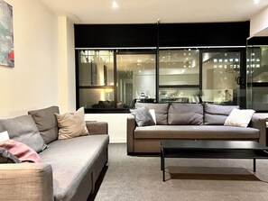City Apartment | Living area | 40-inch flat-screen TV with digital channels, TV, Netflix - ReadySet Apartments on Little Collins (Melbourne)