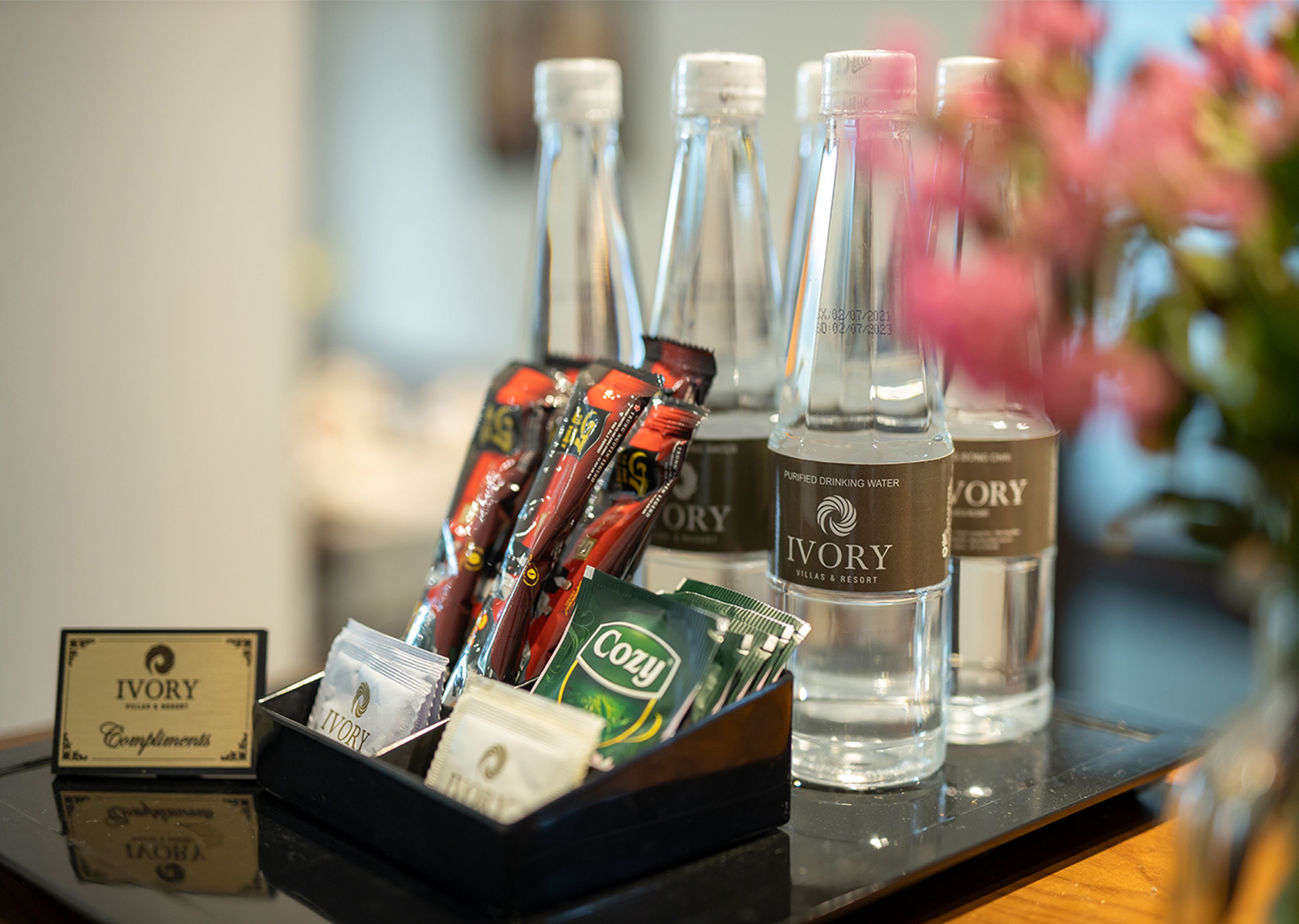 A display of bottled water and toiletries at a hotel reception.