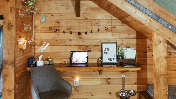 A wooden interior with a staircase, a desk with a computer, a chair, and a framed picture saying "I love you know". - Mt. Sherman Cabin - Ozark Mountains (Jasper)