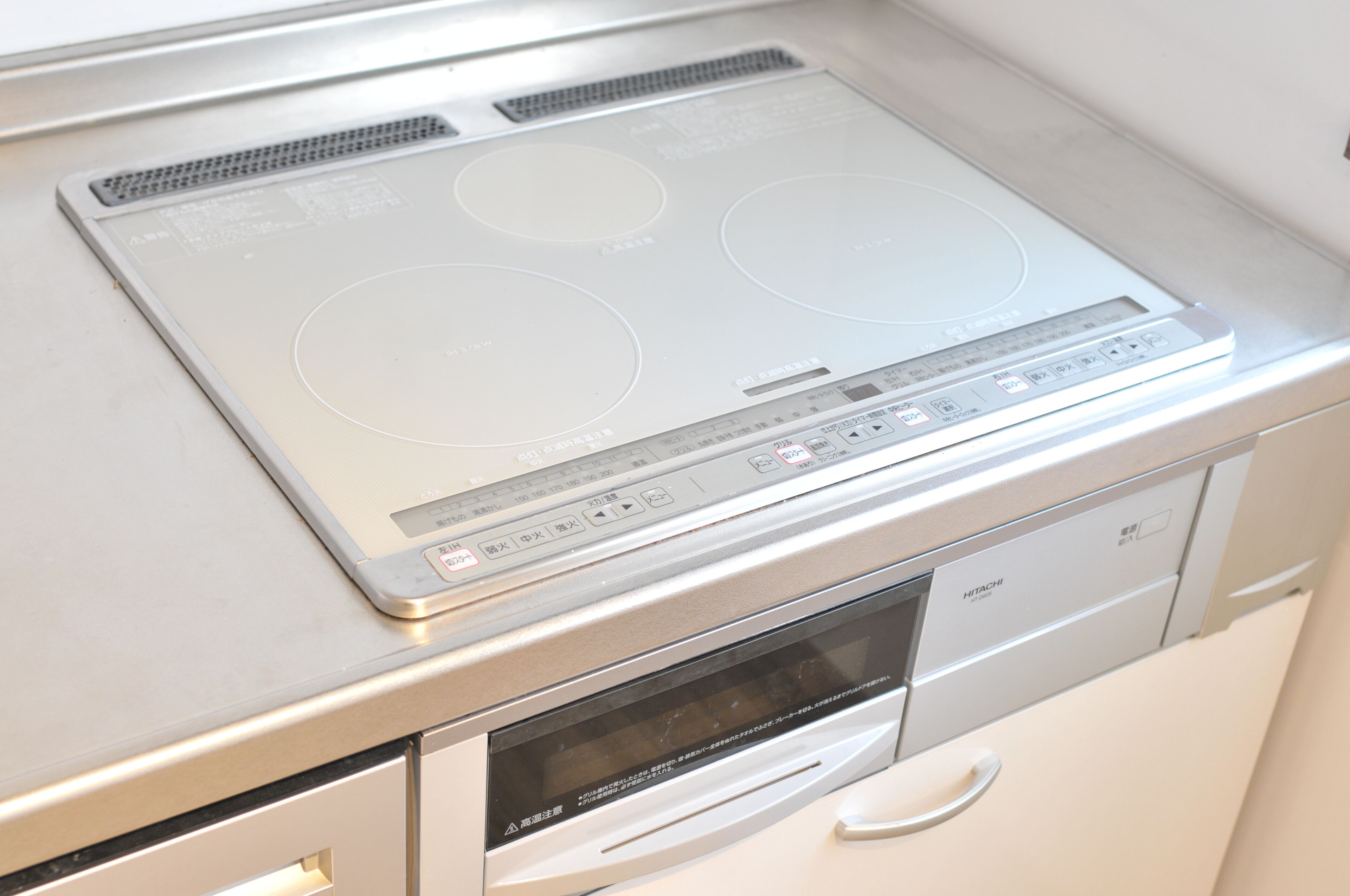 A kitchen with a built-in stovetop, oven, and microwave.