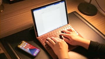 Desk, laptop workspace, blackout drapes, iron/ironing board