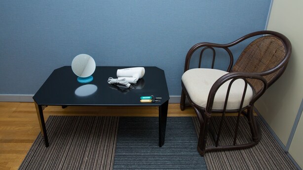 A small room with a black table, a chair, and a blue wall. - Uzumasa 201 (Kyoto)