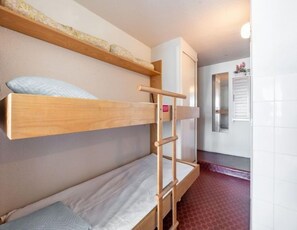 Cozy bunk bed arrangement with a wooden ladder for easy access.
